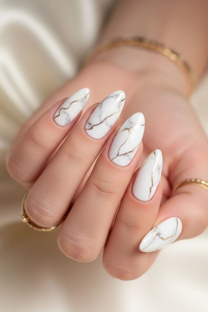 White & Gold Marble Almond Nails